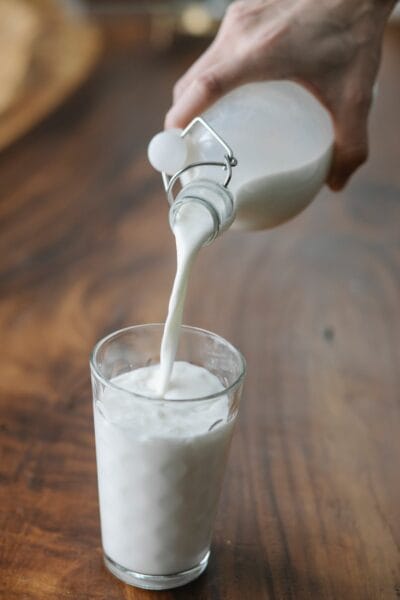 pouring kefir in a glass