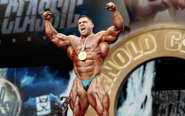 Posing with trophy Derek Lunsford Olympia 2025