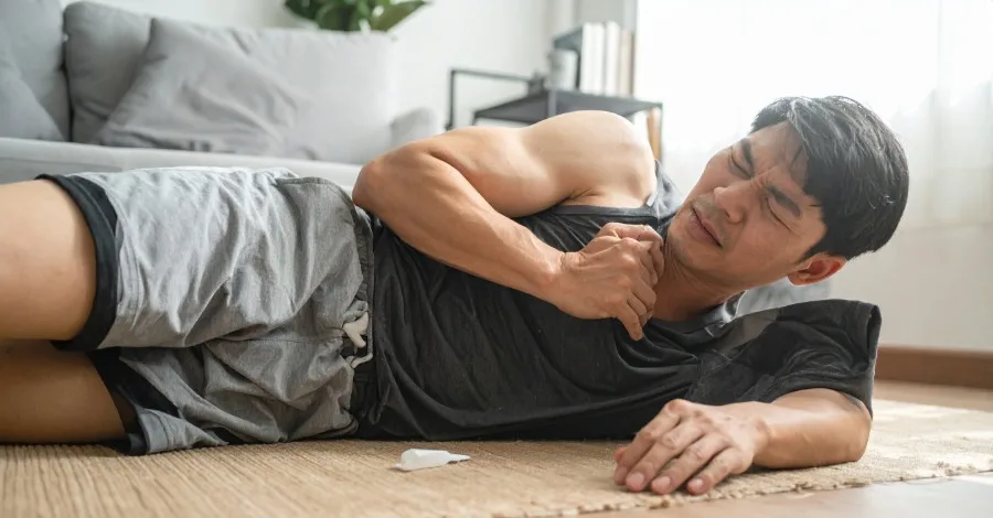 An athlete is lying on the floor with body aches after overusing Berberine